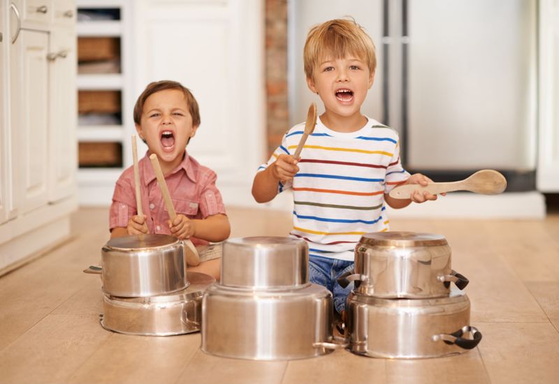 Boys playing music with utensils